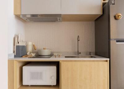 Modern kitchen with sink, microwave, and built-in cabinetry