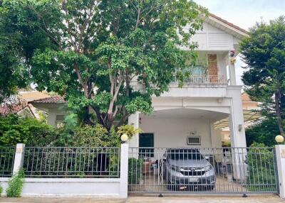 Two-story house with a garage and garden