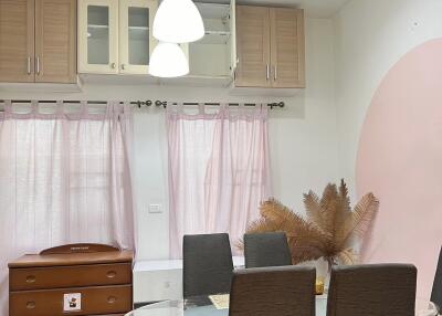 Modern dining area with glass table and stylish chairs