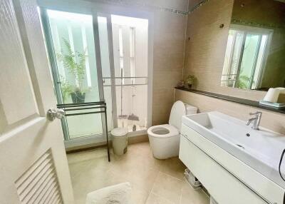 Modern bathroom with sliding glass doors and natural light