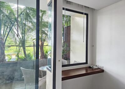 View from inside towards balcony with greenery