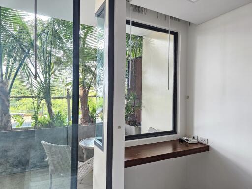 View from inside towards balcony with greenery