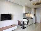 Modern kitchen and dining area with wall-mounted TV