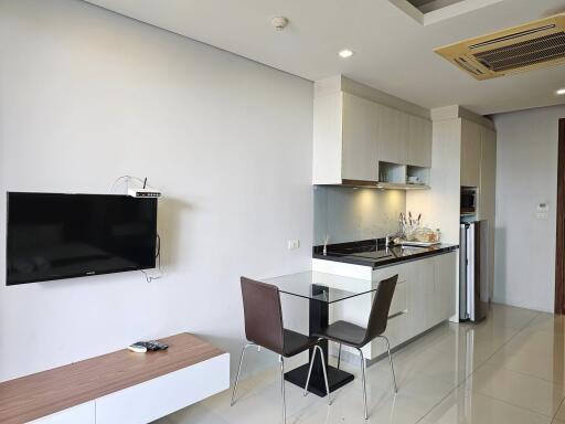 Modern kitchen and dining area with wall-mounted TV