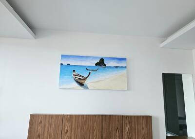 Bedroom decorated with a beach-themed painting