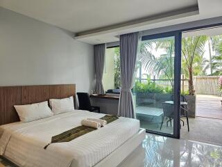 Modern bedroom with large window and view of outdoor patio