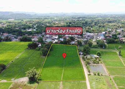 Aerial view of a large plot of land with surrounding greenery