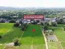 Aerial view of a large plot of land with surrounding greenery