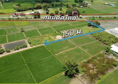 Aerial view of land plots with measurement indication and nearby road