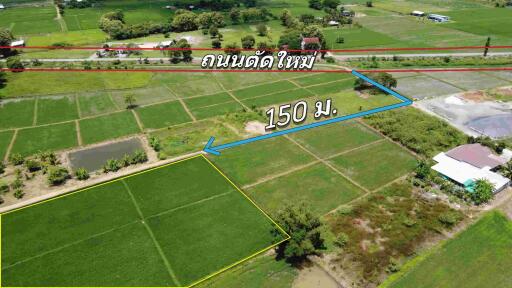 Aerial view of land plots with measurement indication and nearby road