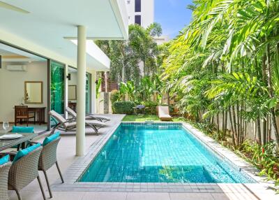 Modern outdoor area with a swimming pool and lounge seating