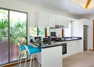 Modern kitchen with white cabinets and stainless steel appliances