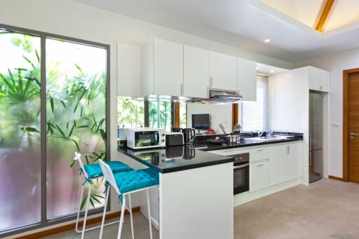 Modern kitchen with white cabinets and stainless steel appliances