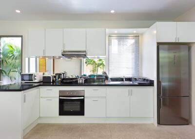 Modern kitchen with white cabinetry and stainless steel appliances