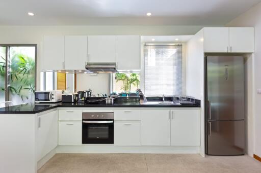 Modern kitchen with white cabinetry and stainless steel appliances