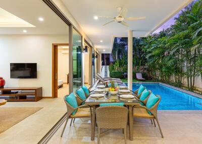 Covered outdoor dining area next to a pool