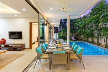 Covered outdoor dining area next to a pool