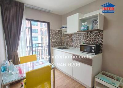 Modern kitchen with dining area and a small balcony