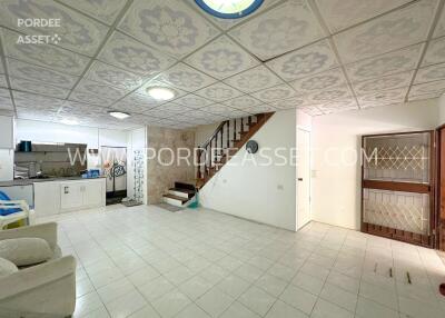 Living area with staircase and kitchenette