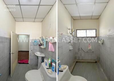 Bathroom with tiled walls and floor, sink, and shower area