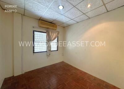 Empty bedroom with windows and ceiling lights