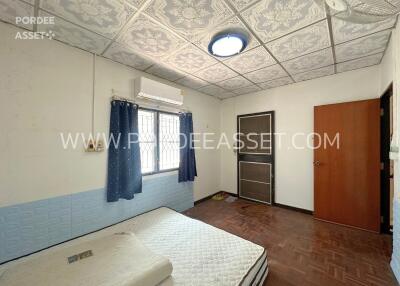 bedroom with printed ceiling panels and double bed