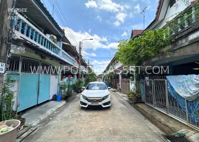 Residential street view with houses and a car