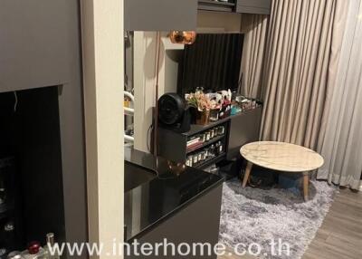 Photo of a cozy living space with decorative shelving and a small round coffee table