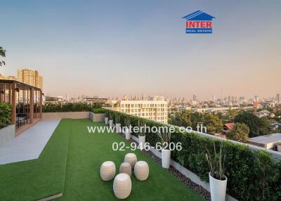 Spacious and landscaped rooftop terrace with city skyline view