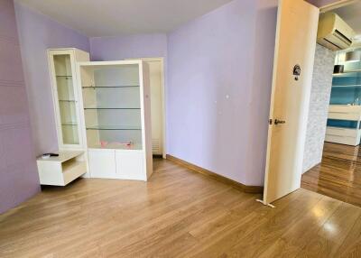 Spacious living room with wood flooring and built-in shelves