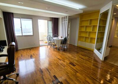 Spacious main living area with wooden flooring and large windows