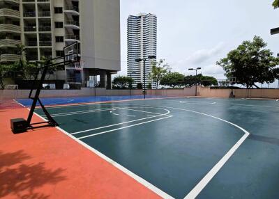 Basketball and sports court with high-rise buildings in the background