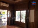 Living room with large window and wooden paneling