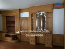 Wooden living room feature wall with intricate design mirror