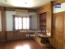 Cozy living room with wooden panels and window