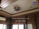 Living room ceiling with wooden paneling and chandelier