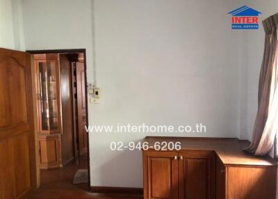 Living area with wooden furniture and window