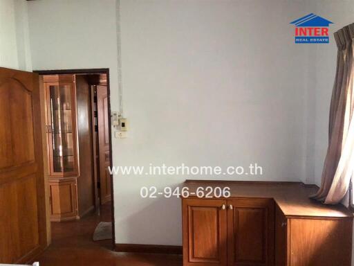 Living area with wooden furniture and window