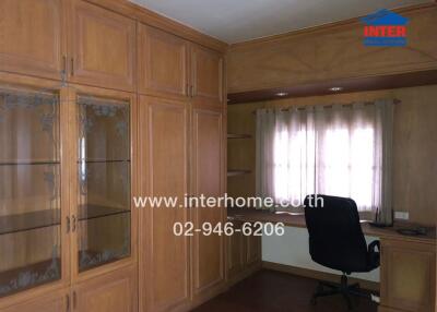 Home office with built-in wooden cabinets and desk