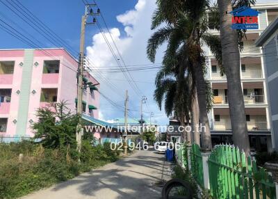 Street view with residential buildings and palm trees