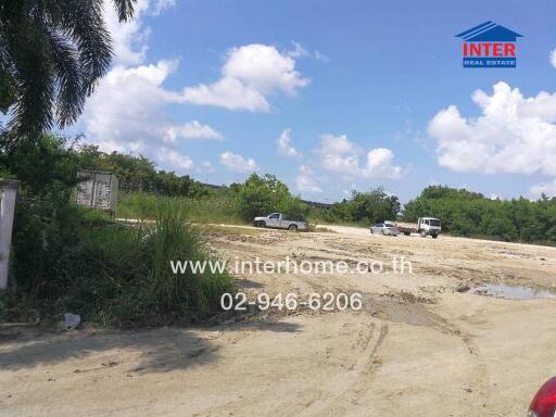 Vacant land with vehicles parked and clear skies