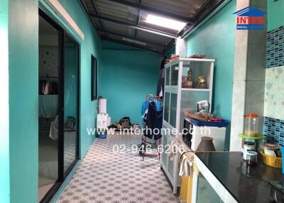 Blue kitchen with tiled floor and glass cabinets