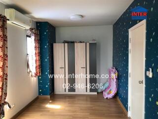 Bedroom with wooden floor, blue and white themed decor featuring wardrobes, air conditioning, and window with curtains