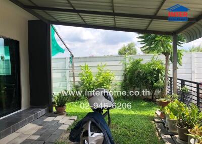 Outdoor patio with plants and seating area