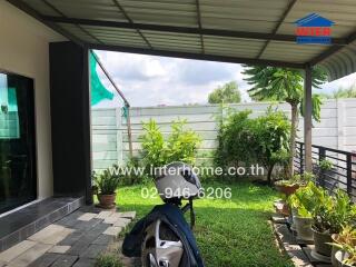 Outdoor patio with plants and seating area