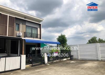 Exterior view of a modern two-story house with attached carport