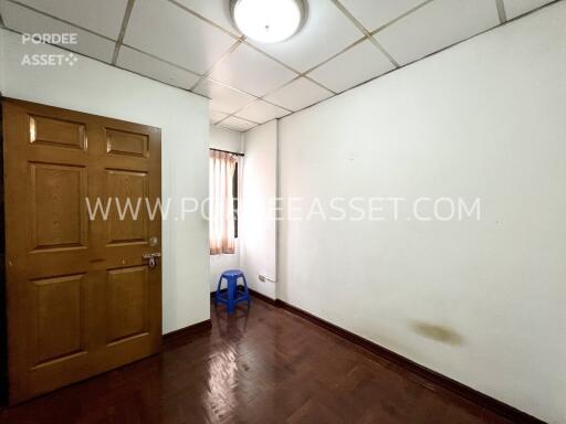 Empty bedroom with wooden floor and a window