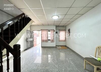 Spacious living room with stairs and large windows