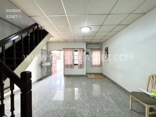 Spacious living room with stairs and large windows