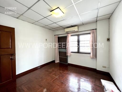 Standard bedroom with wooden floor and window